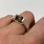 Smokey quartz silver smile ring design shown on finger
