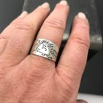 drawing on ring, wide band on finger with self portrait