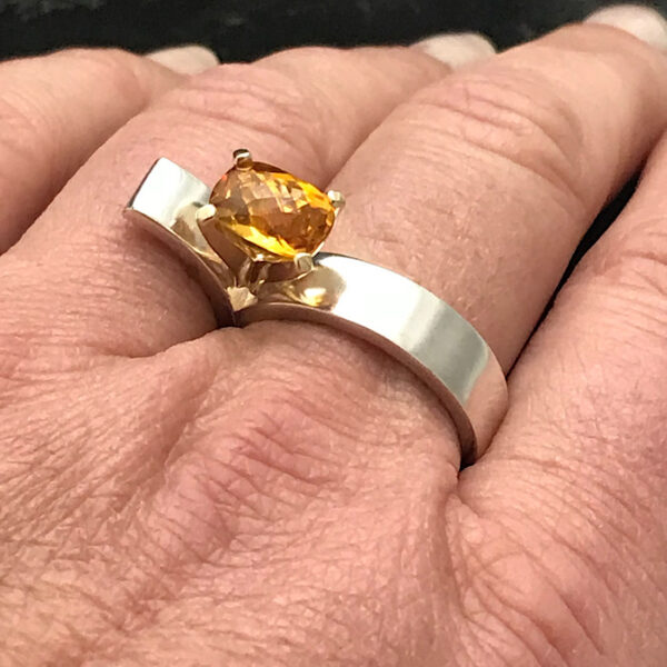 Yellow citrine ring on the hand