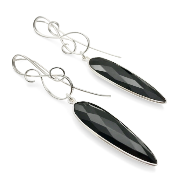 Onyx Gallery earrings dangle with ornamented and detailed silver top, long earrings