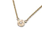 Textured disc pendant necklace with diamond, rope chain is holding this very cute little gem