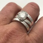 Traditional round halo style diamond engagement ring with diamonds, reused family diamonds