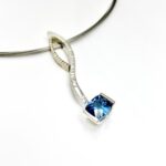 Blue topaz and diamond curve pendants in elegant combo
