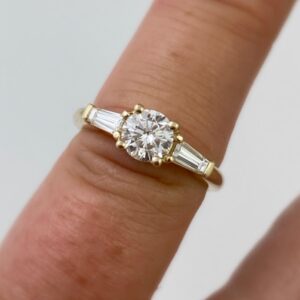 engagement ring tapered diamonds on sides of solitaire diamond